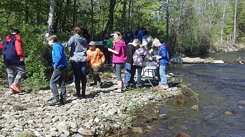 Camden Middle School students stocking Mad River